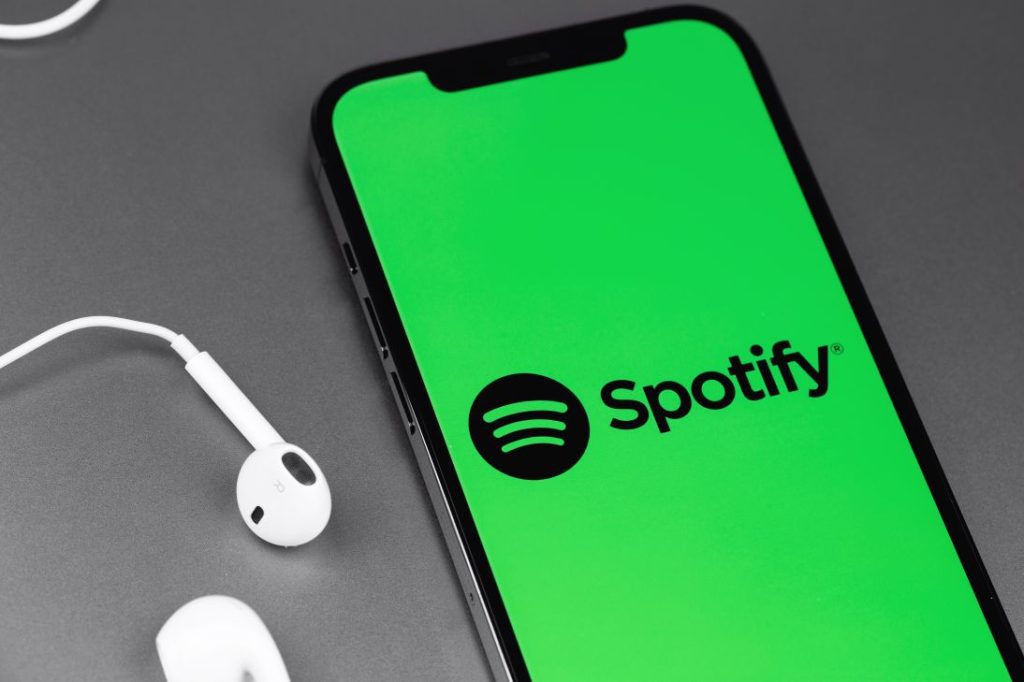 Spotify Logo Next To Pair Of Earbuds
